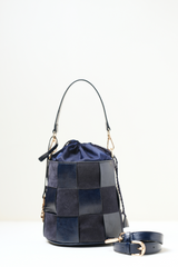 Derby Bucket Bag Blue shown in front view with its structured bucket silhouette and soft blue finish.