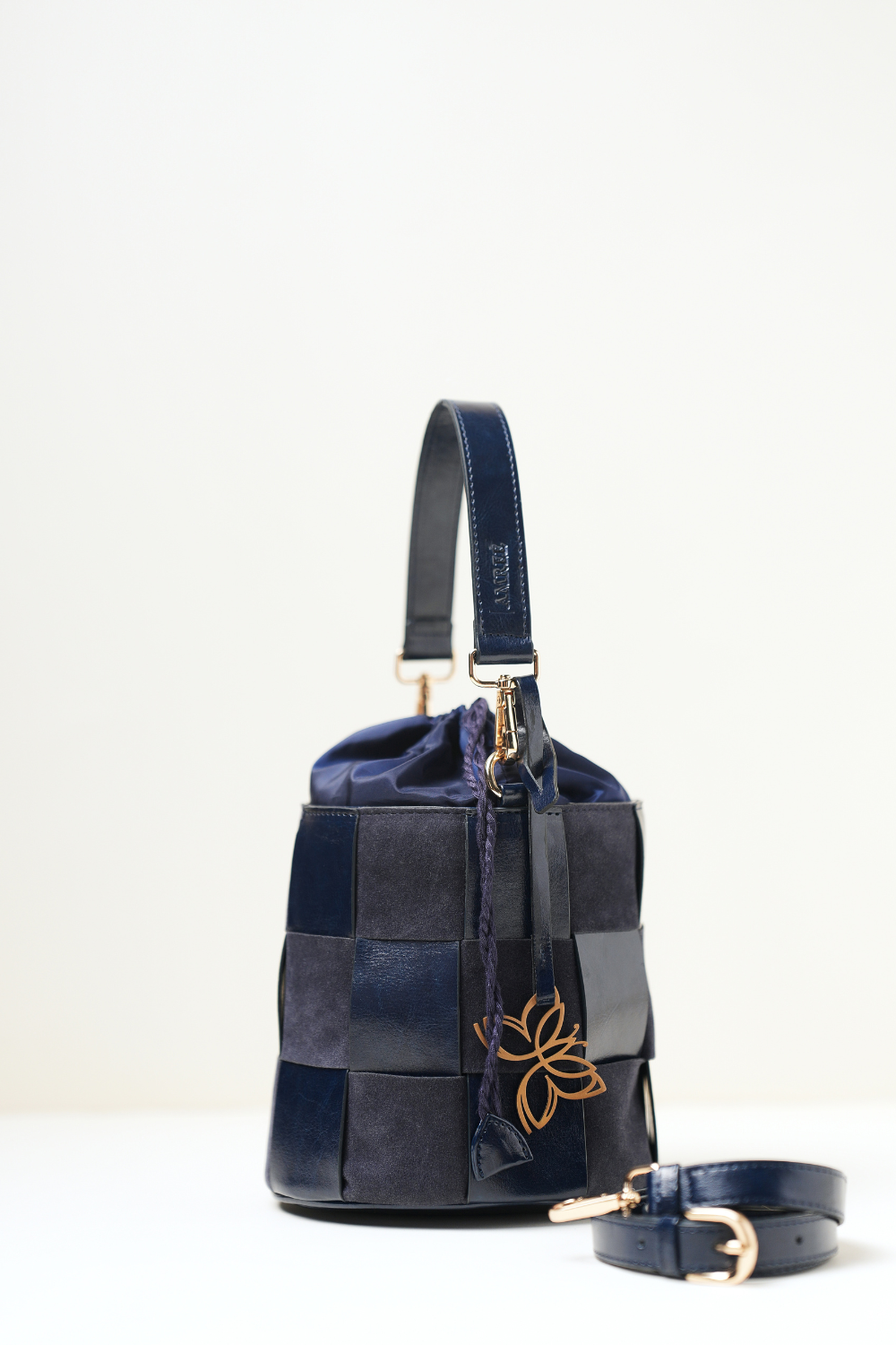 Side angle view of the Derby Bucket Bag Blue.