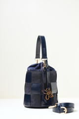 Side angle view of the Derby Bucket Bag Blue.