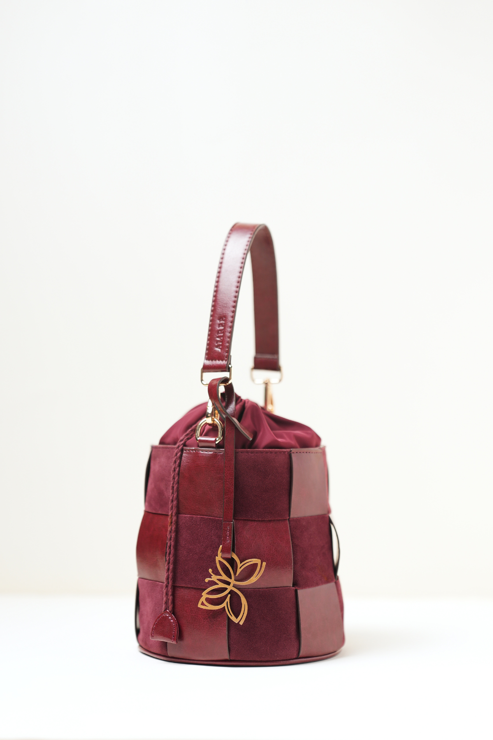 Side angle view of the Derby Bucket Bag Burgundy.