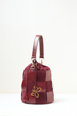 Side angle view of the Derby Bucket Bag Burgundy.