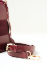 Derby Bucket Bag Burgundy shown with its adjustable shoulder strap.