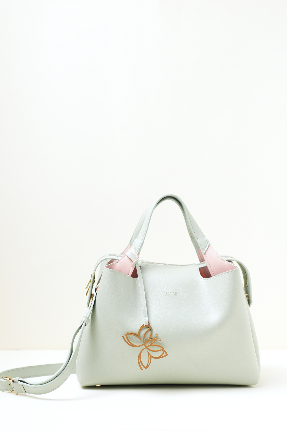 Mint green Equitana top-handle bag showing structured silhouette and premium finish.