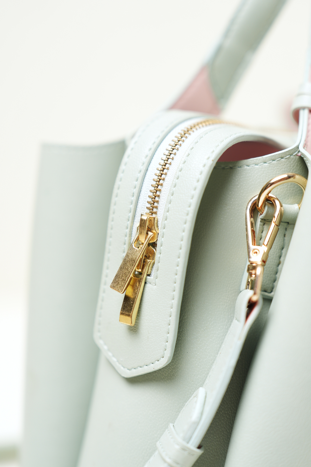 Equitana Top Handle Mint purse displayed with its curved handle and minimal design.