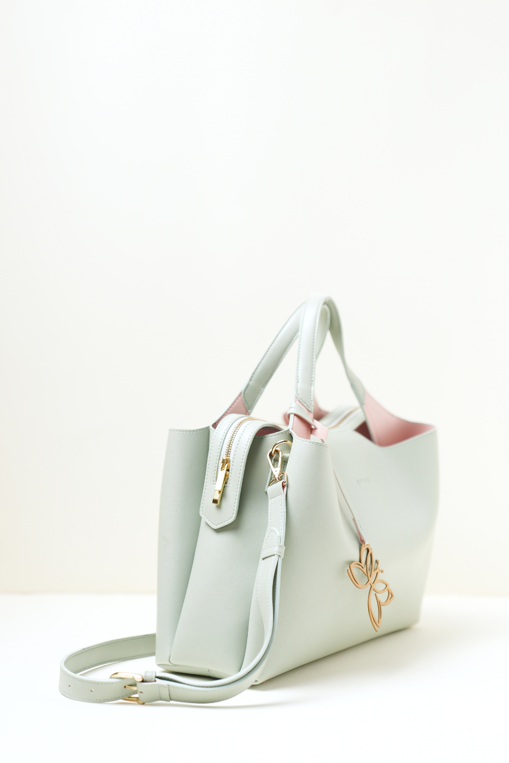 Equitana Top Handle Mint handbag in soft mint green placed on a clean background.
