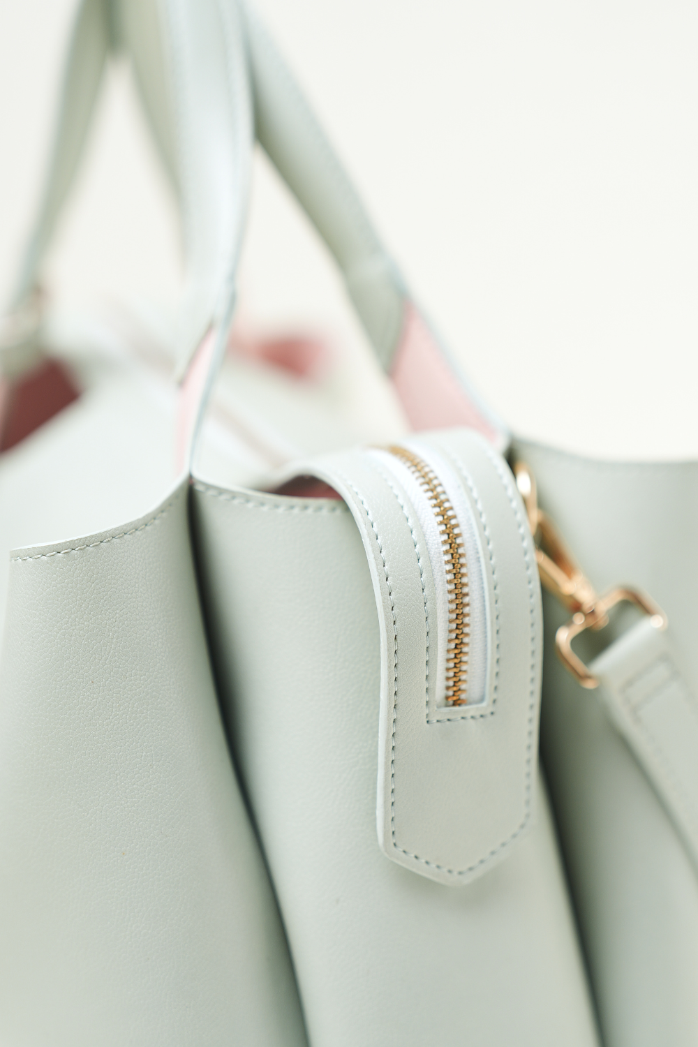 Side view of the Equitana Top Handle Mint handbag showing shape and detailing.