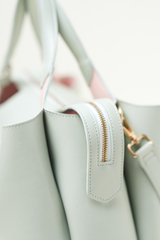 Side view of the Equitana Top Handle Mint handbag showing shape and detailing.