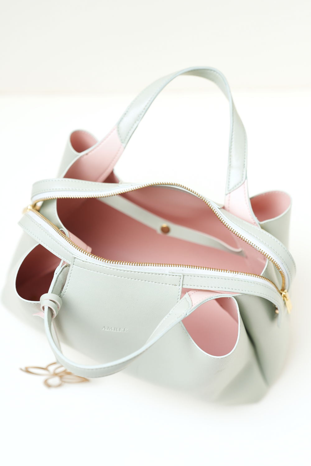Top-down shot of the Equitana Top Handle Mint handbag showing handle and opening.