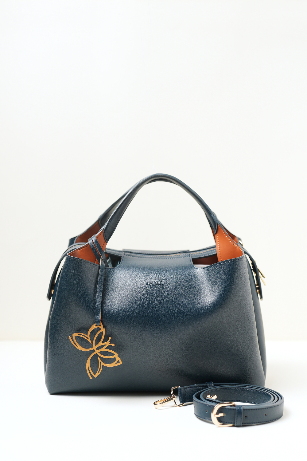 Equitana Top Handle Navy handbag in deep navy blue placed on a clean background.