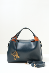 Equitana Top Handle Navy handbag in deep navy blue placed on a clean background.