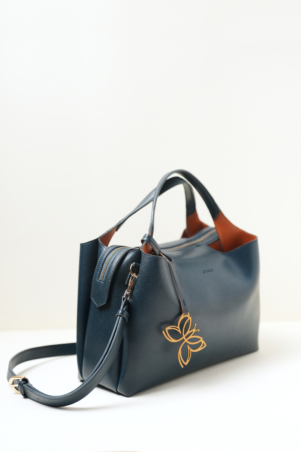 Navy blue Equitana top-handle bag showing its structured silhouette and premium finish.