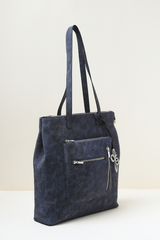 Blue Rodeo Totepack displayed from a side angle highlighting its sleek profile and stitching.
