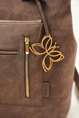 Detailed close-up of the Rodeo Totepack Brown showing the Amrée logo tag with clean stitching and textured leather finish.