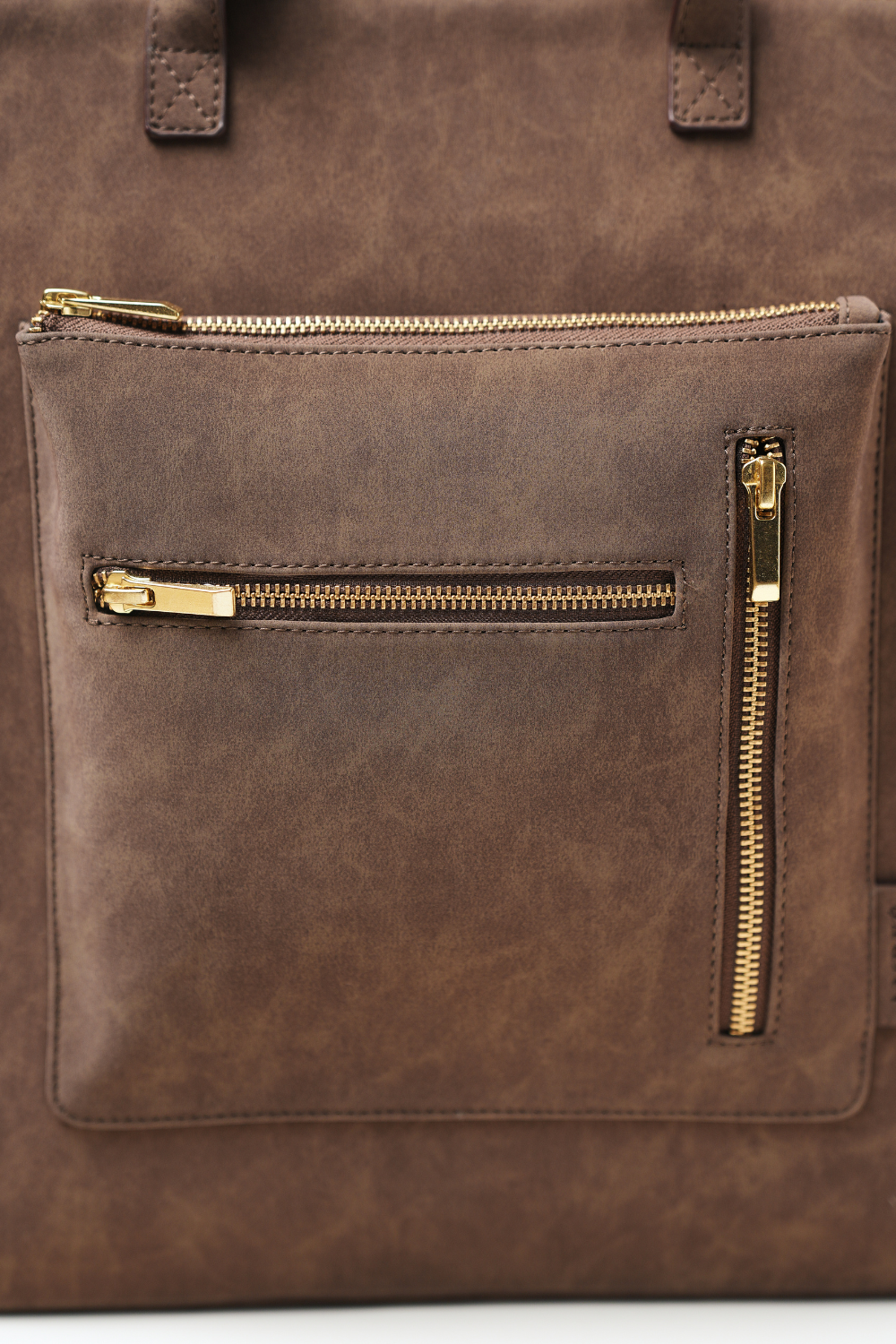 Close-up view of the Rodeo Totepack Brown front pocket showing stitching, chain clean detailing.