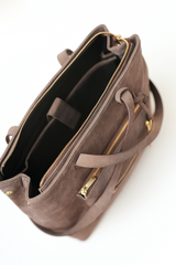 Sideways top view of the Rodeo Totepack Brown with the bag open, showing inner compartments and Amrée’s organised interior layout.