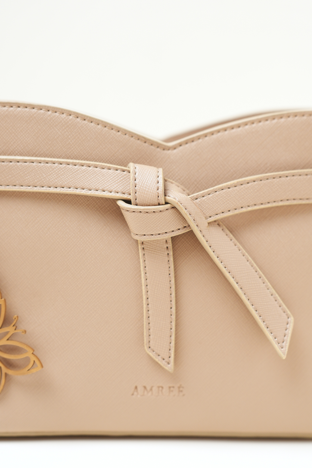 Close-up of the Rosette Sling Beige showing the Amrée logo