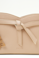 Close-up of the Rosette Sling Beige showing the Amrée logo