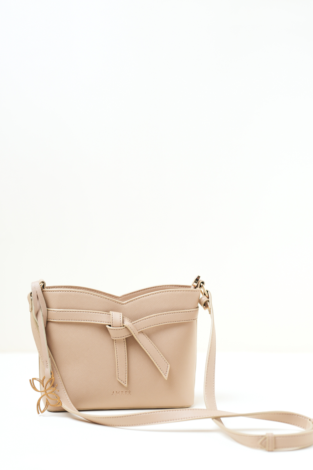Minimal front view of the Rosette Sling Beige on a clean background, highlighting its compact shape, smooth beige finish, and elegant design.