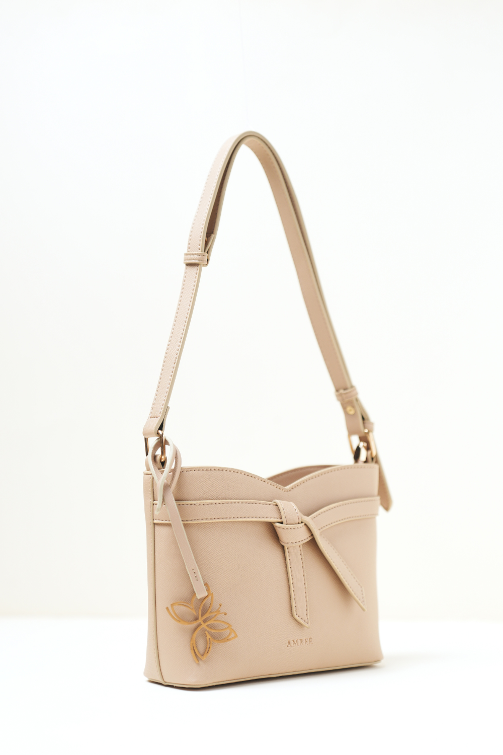 Side angle view of the Rosette Sling Beige showing its curved profile and clean stitching.