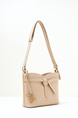 Side angle view of the Rosette Sling Beige showing its curved profile and clean stitching.