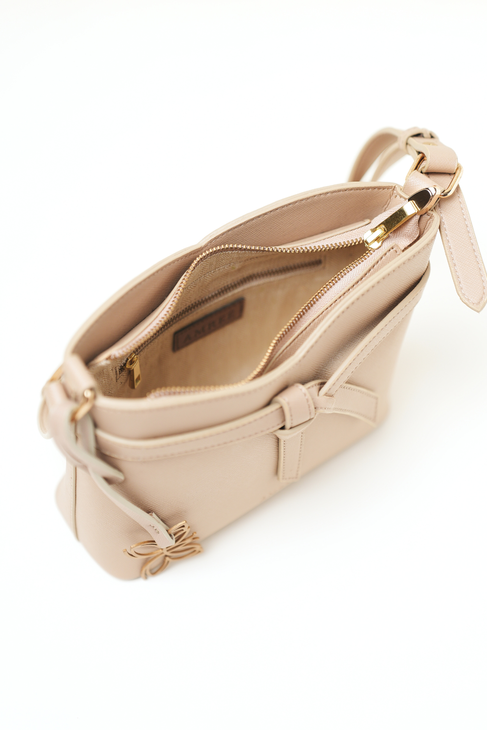 Top view of the Rosette Sling Beige showing the opening and strap attachment design.