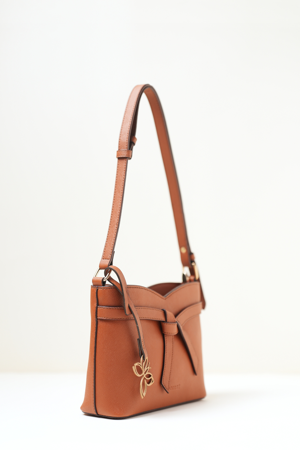 Side angle view of the Rosette Sling Tan showing its curved profile and premium stitching.